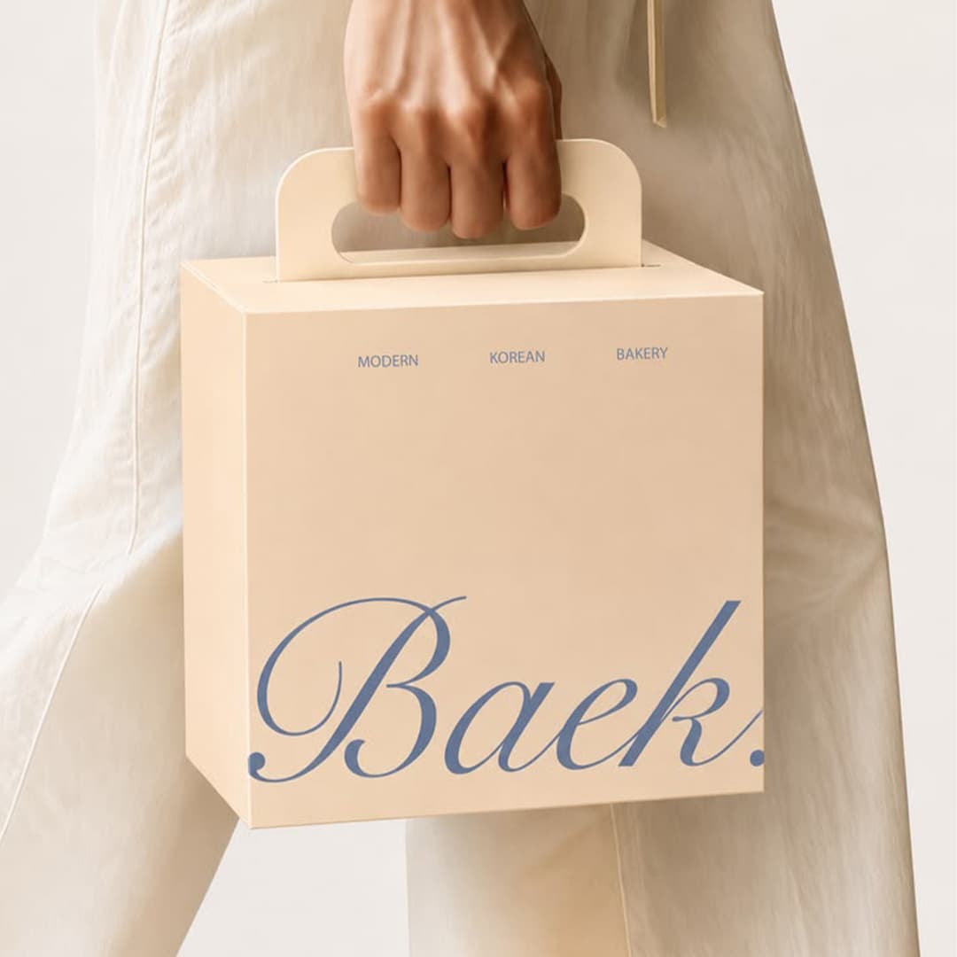 Baker holding a custom cake box